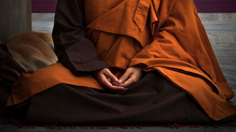 a person in a robe and brown robe